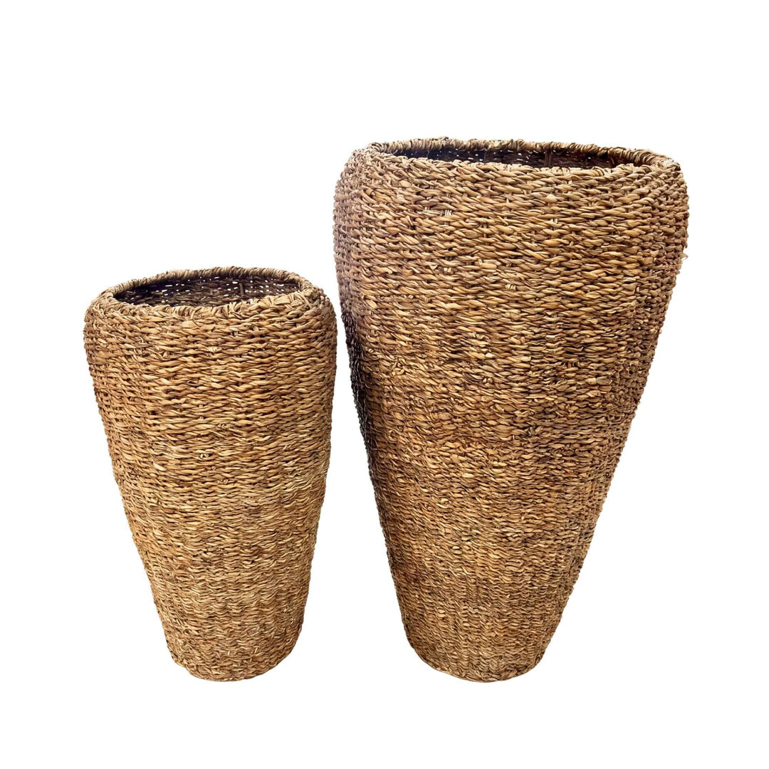 Front view of the straw baskets showing the two available sizes and woven natural straw texture.