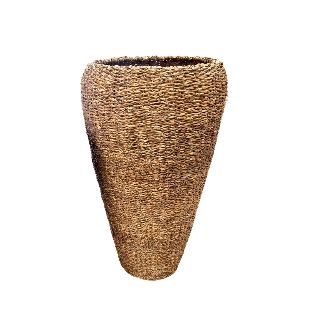 Front view of the larger straw basket highlighting its tapered shape and handwoven finish.