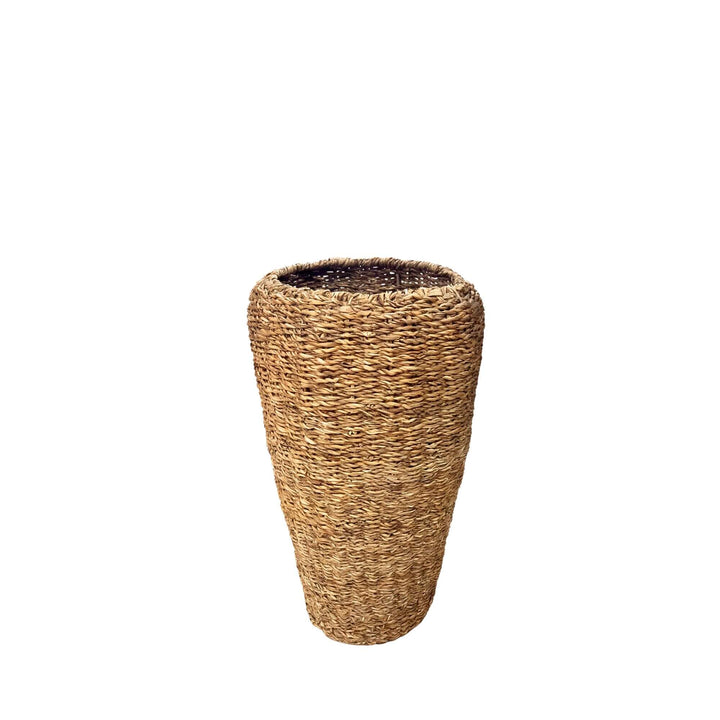 Front view of the smaller straw basket showing its natural woven form and warm straw tones.