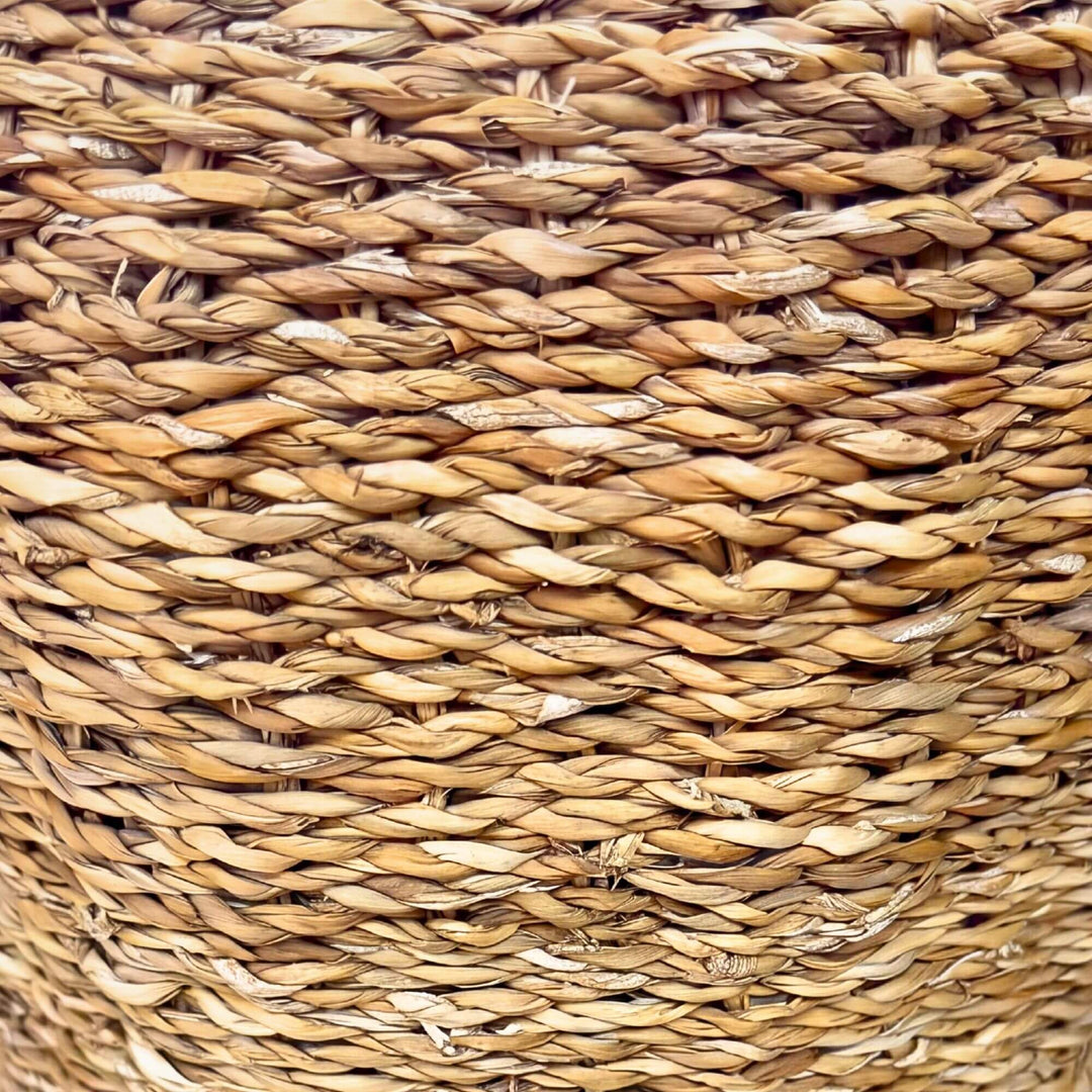 Close-up detail of the woven straw surface showing the natural texture and handcrafted pattern.