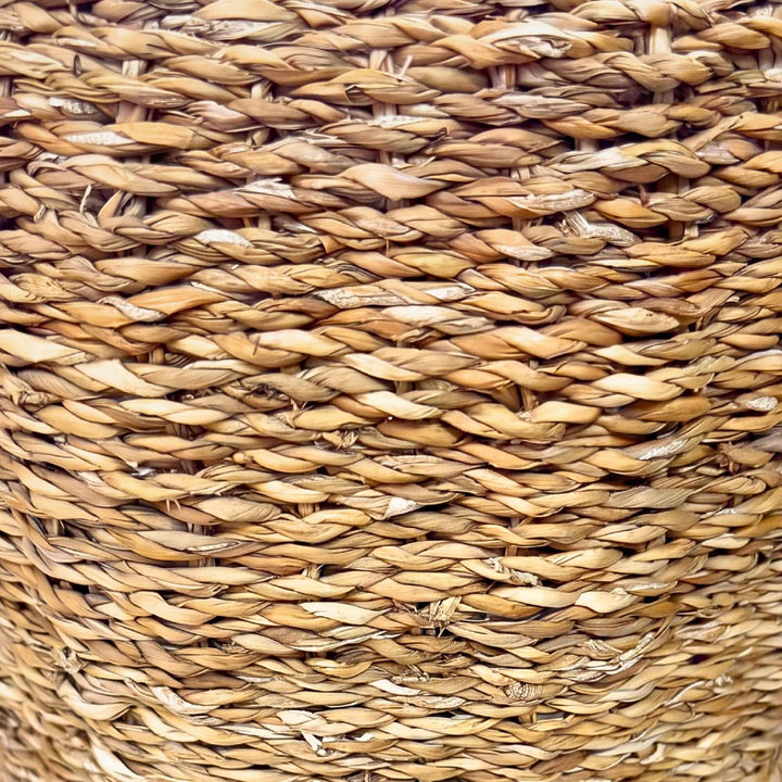 Close-up detail of the woven straw surface showing the natural texture and handcrafted pattern.