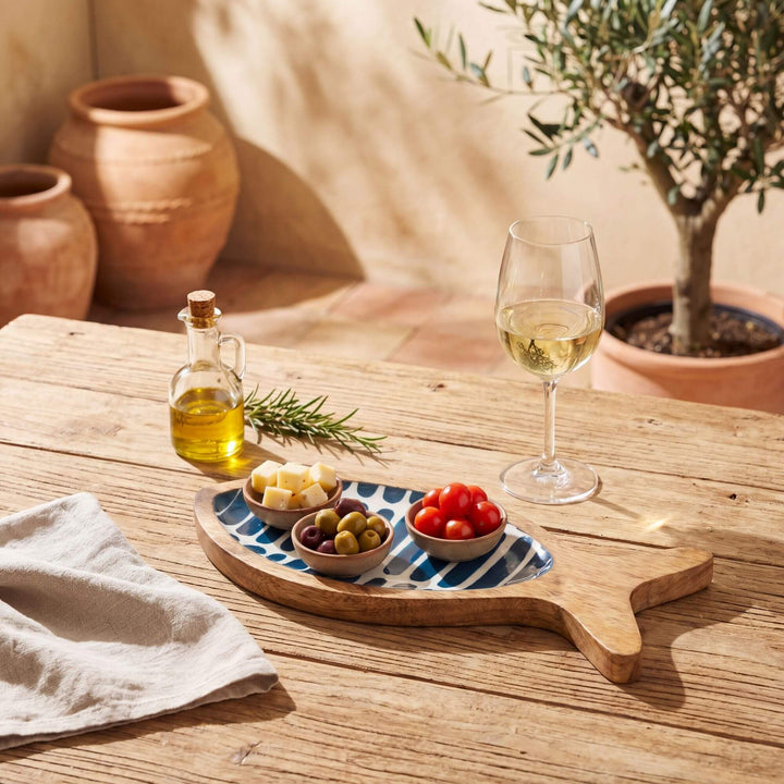 Styled outdoor-inspired table setting with the striped fish tray used as a decorative serving piece.
