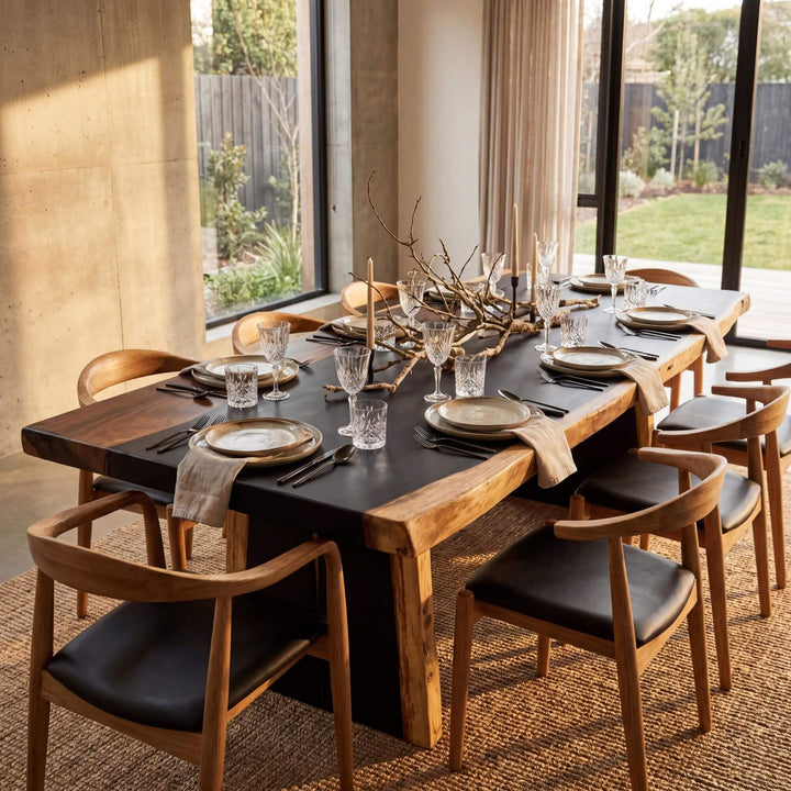 Styled dining room setting featuring the Suar Lake table in a warm contemporary interior.