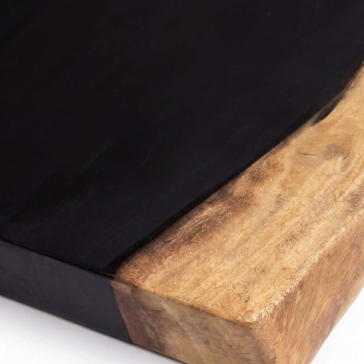 Close-up detail of the tabletop edge showing the contrast between the dark center section and natural suar wood.