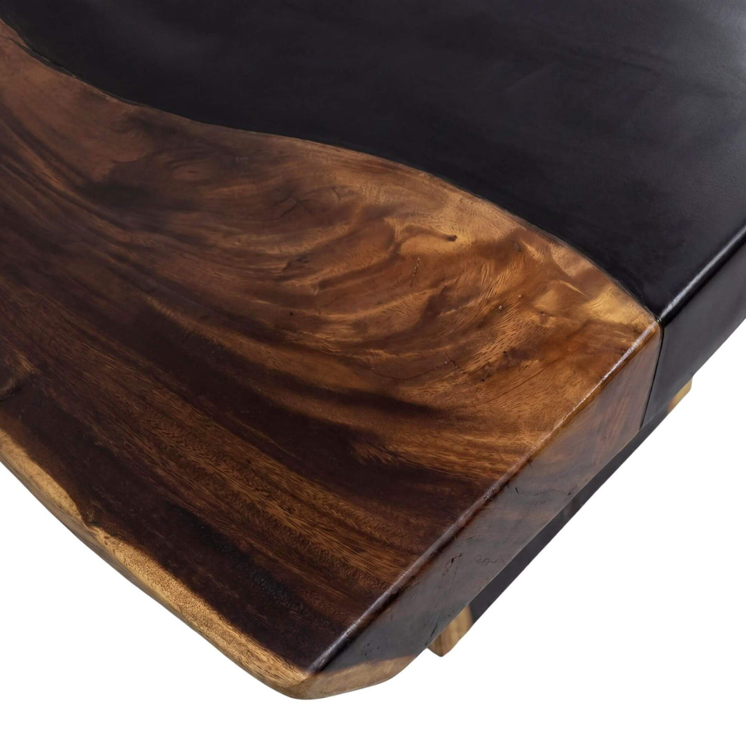Angled close-up of the tabletop highlighting the rich suar grain and dark inlay detail.