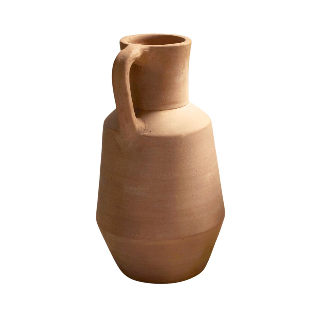 Front view of the Sula terracotta vase highlighting its sculptural shape and integrated handle.