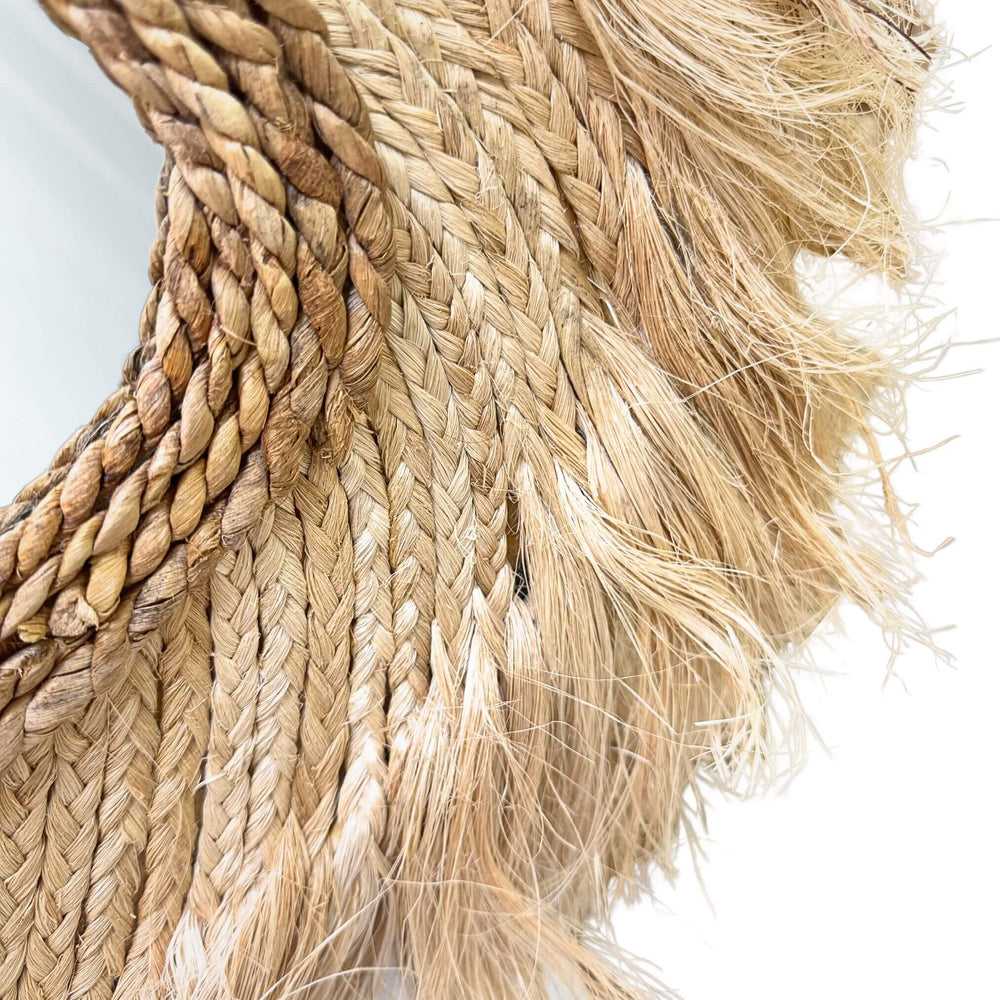 Close-up of Sulawesi Organic Mirror frame in abaca and sisal with textured fringe.