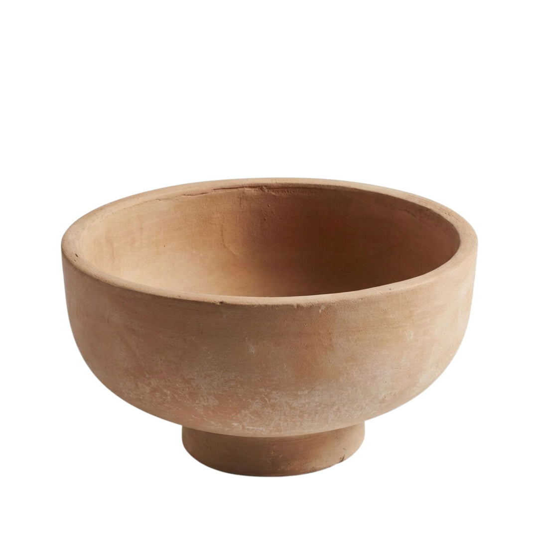 Front view of the Sula terracotta bowl with rounded form and pedestal base.