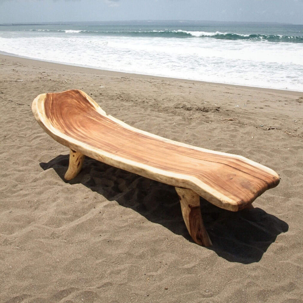 “Suar wood Sumatra Sun Lounger placed on a beach, outdoor furniture inspiration.”