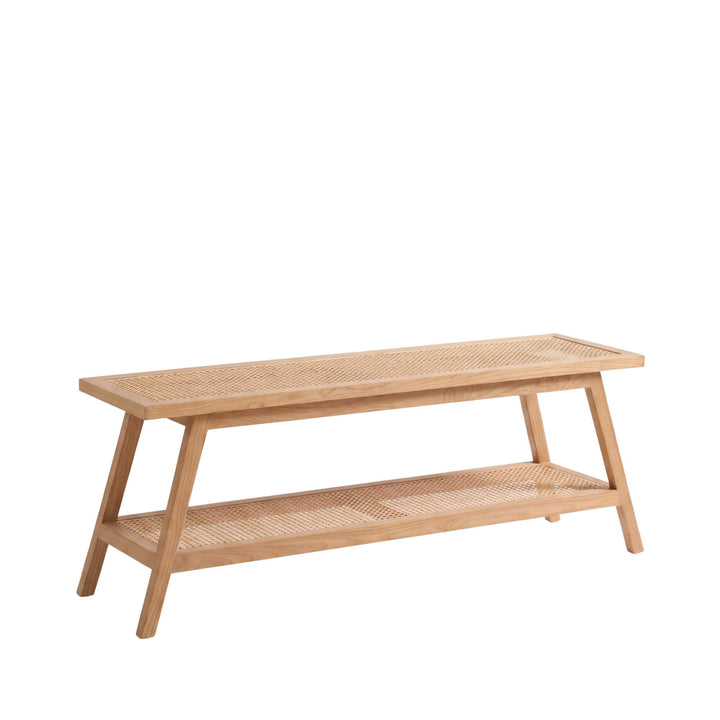 Front angled view of the Senja bench with a sungkai wood frame, woven rattan top, and lower shelf