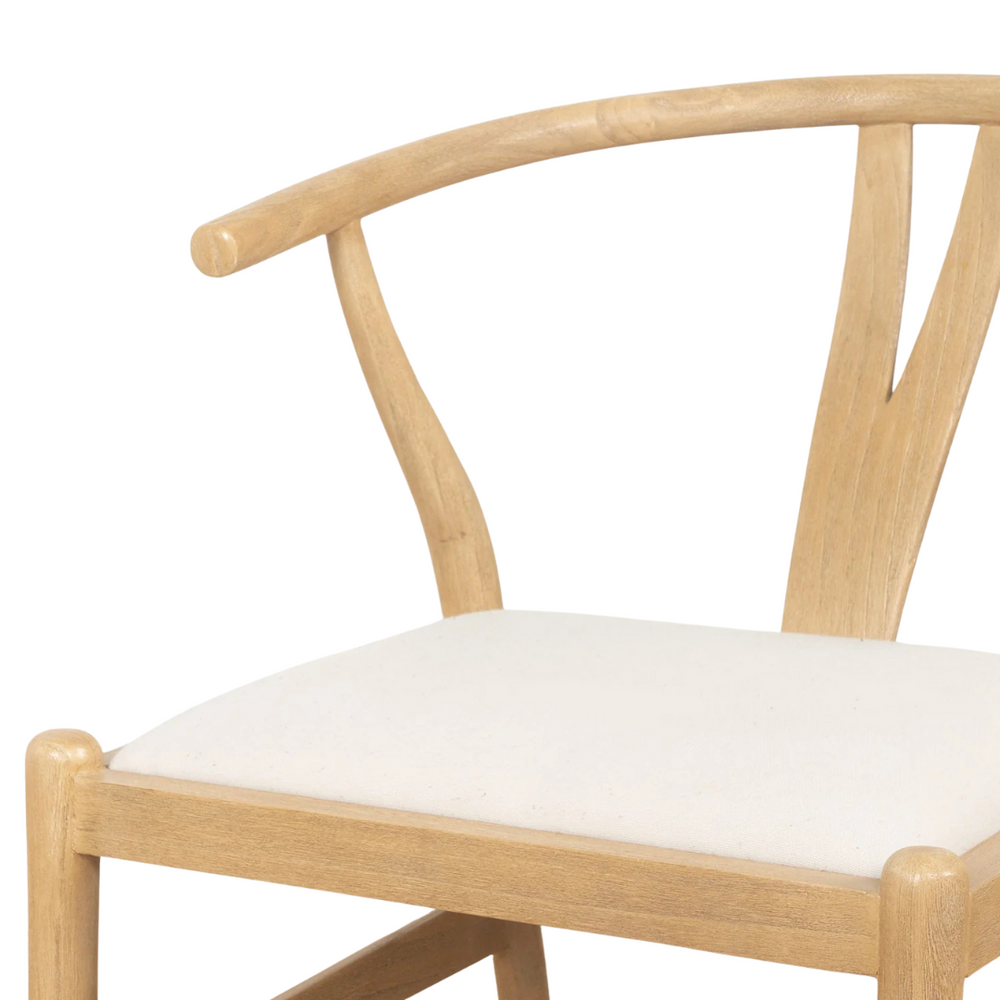 Close-up highlighting the curved backrest of the Senja dining chair and its seat.