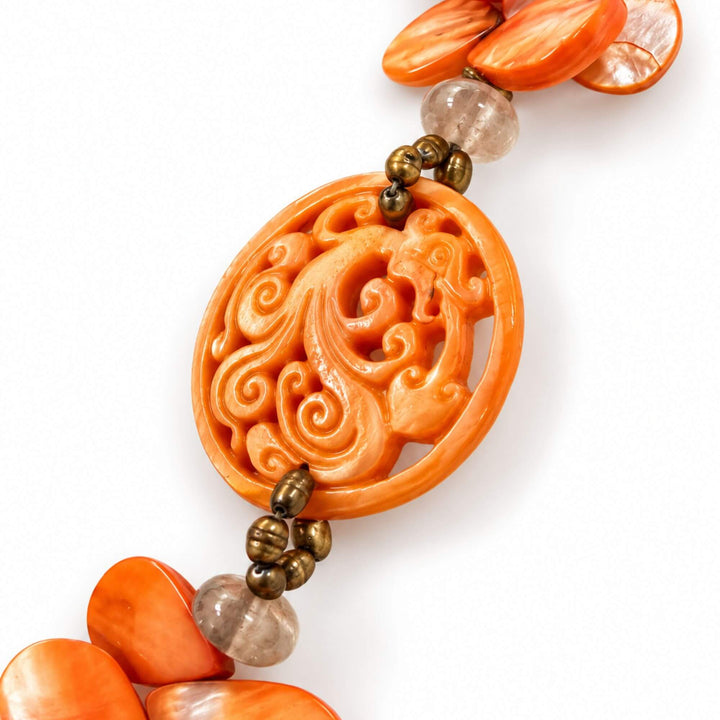 Close-up of the carved orange mother-of-pearl medallion and rock crystal detail