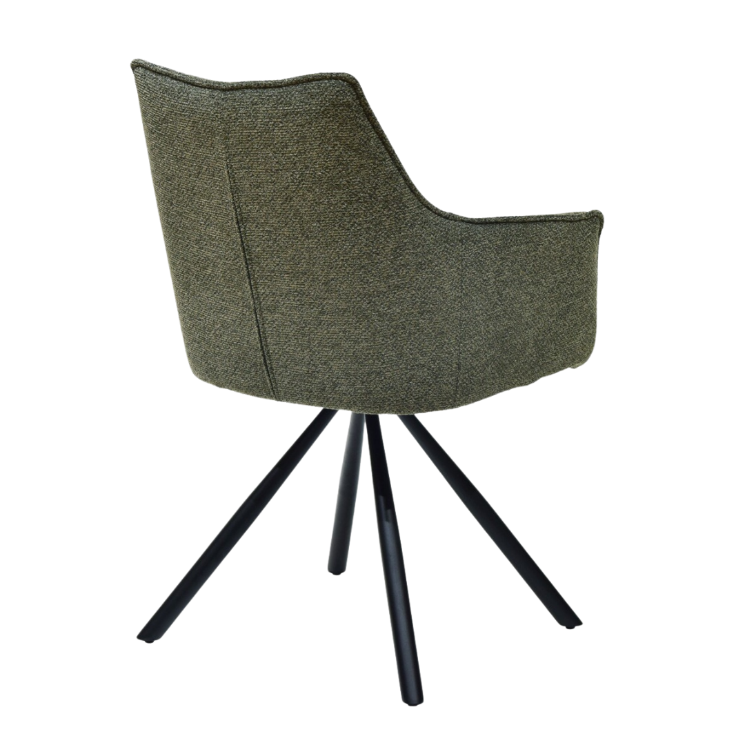 Angled view of sage green Surat dining chair with armrests and fabric seat.