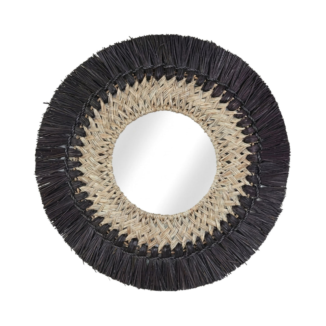 Front view of the Symi round mirror with woven seagrass frame and black fringe detailing.