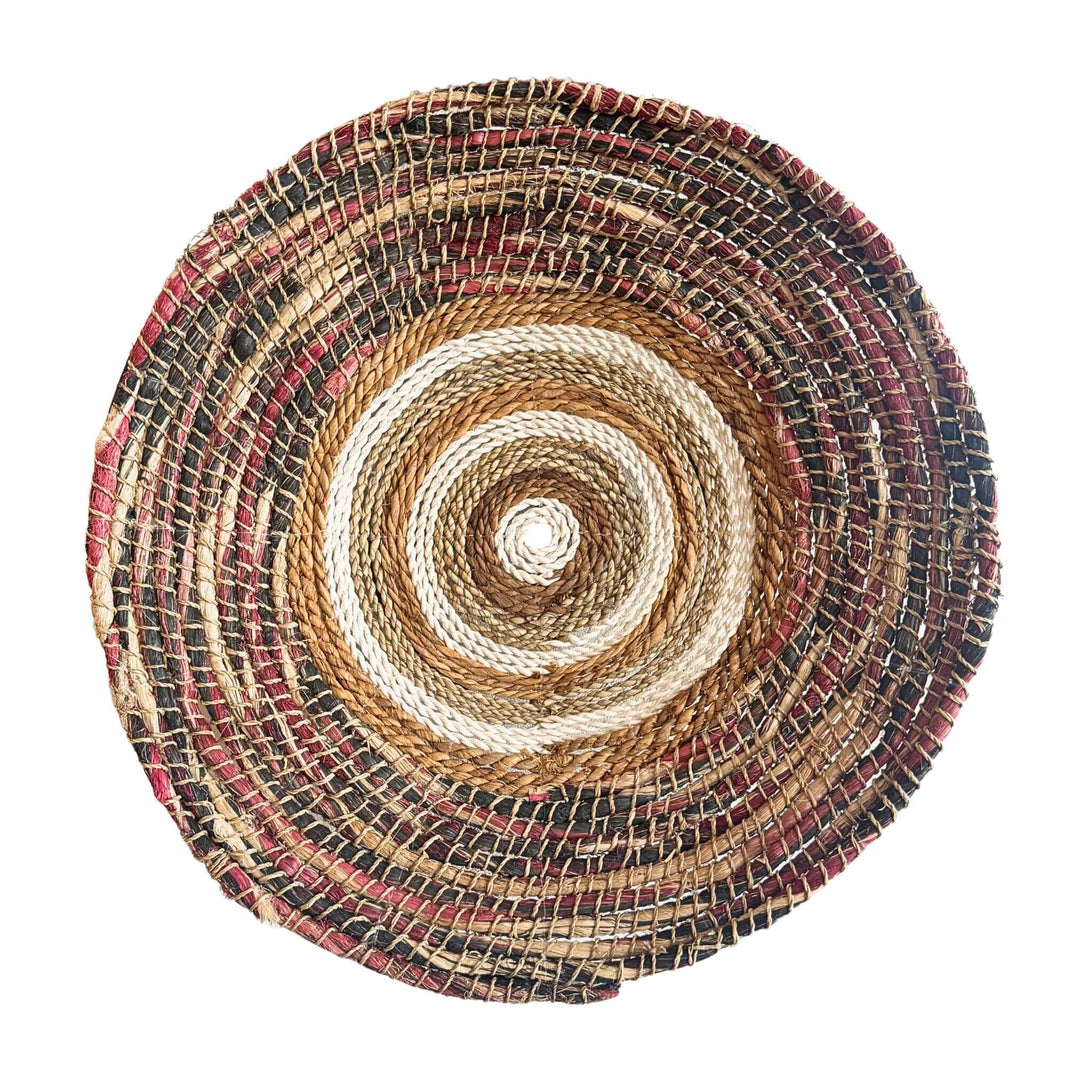 Samara Wall Deco Plate, handwoven from abaca, cotton, and rattan with concentric natural and earthy-toned patterns.