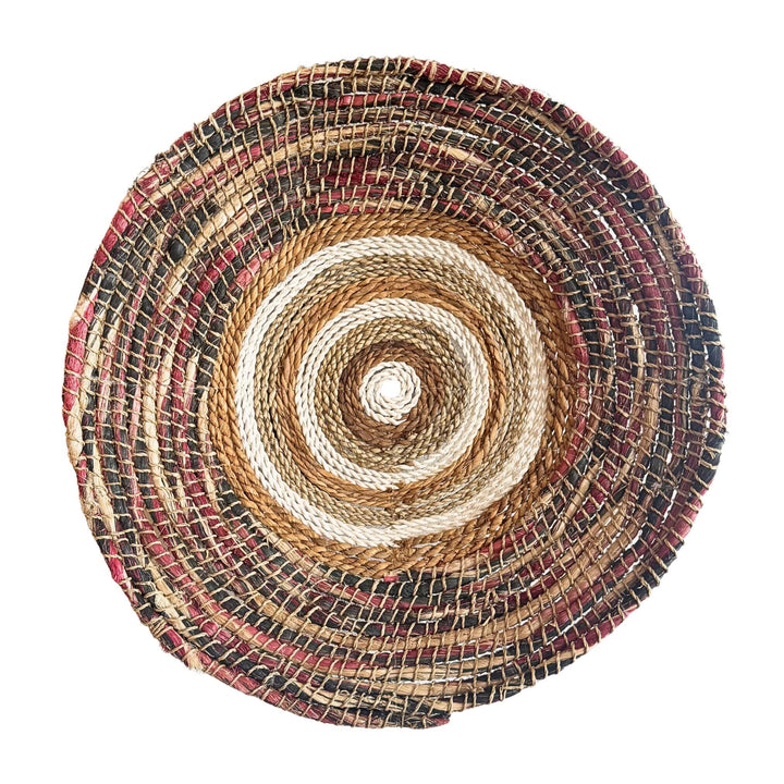 Samara Wall Deco Plate, handwoven from abaca, cotton, and rattan with concentric natural and earthy-toned patterns.