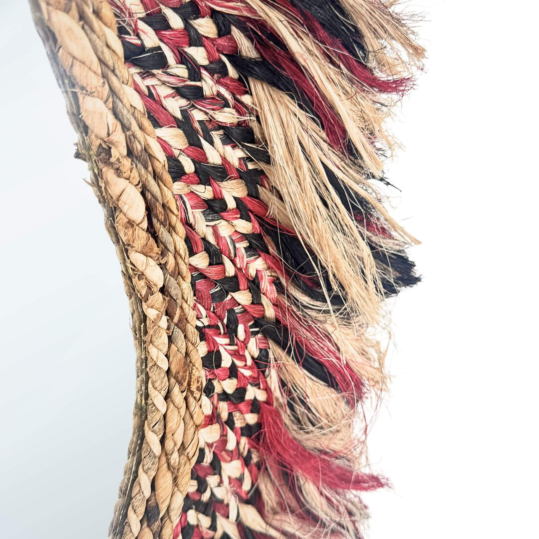 Close-up of a Sawana Mirror with multicolored strands on a white background