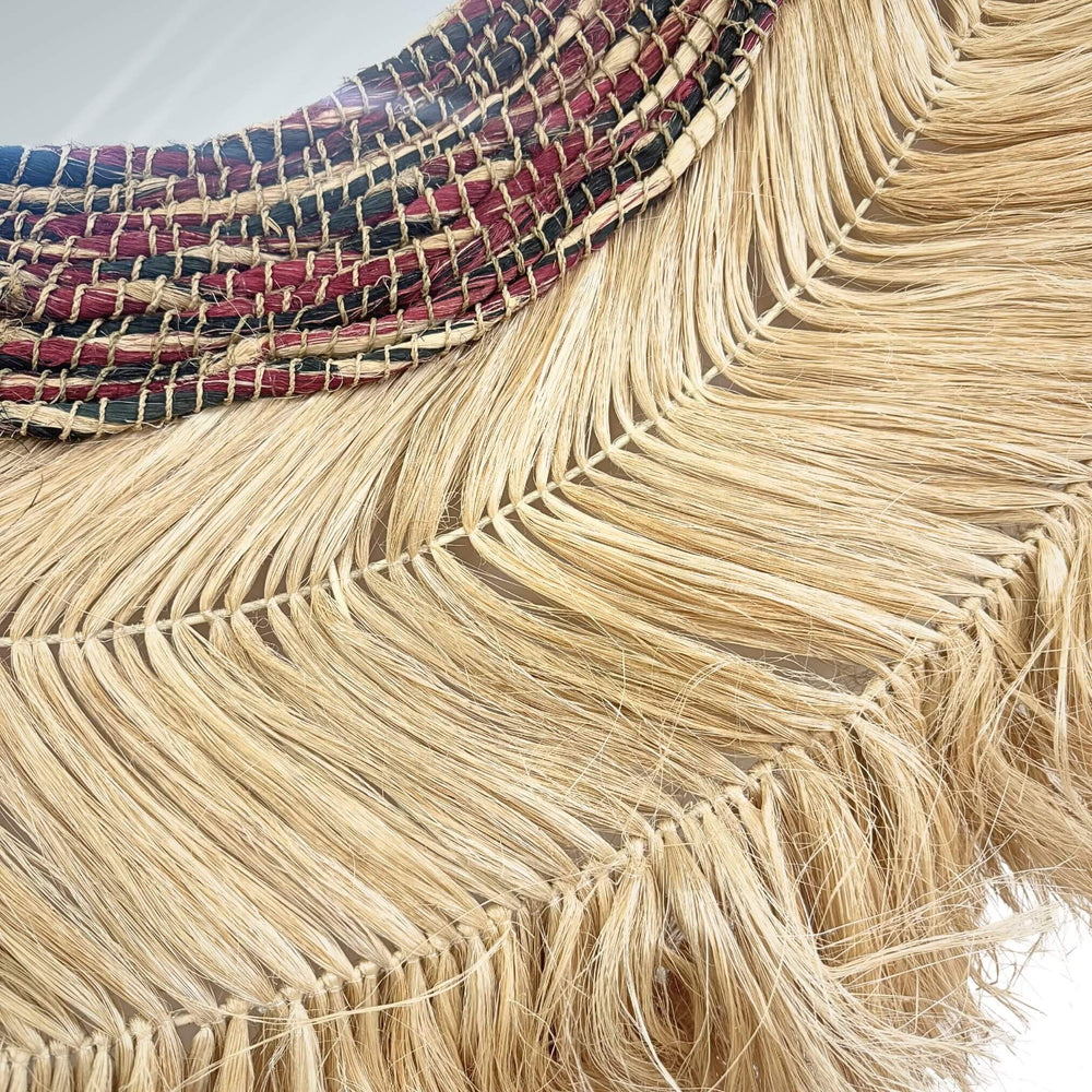 Close-up Surya Mirror, design handcrafted from sisal, abaca, and cotton with layered natural texture.