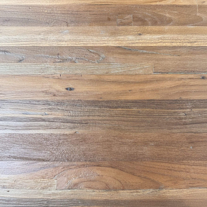 Close-up of the recycled teak tabletop showing natural grain and texture.