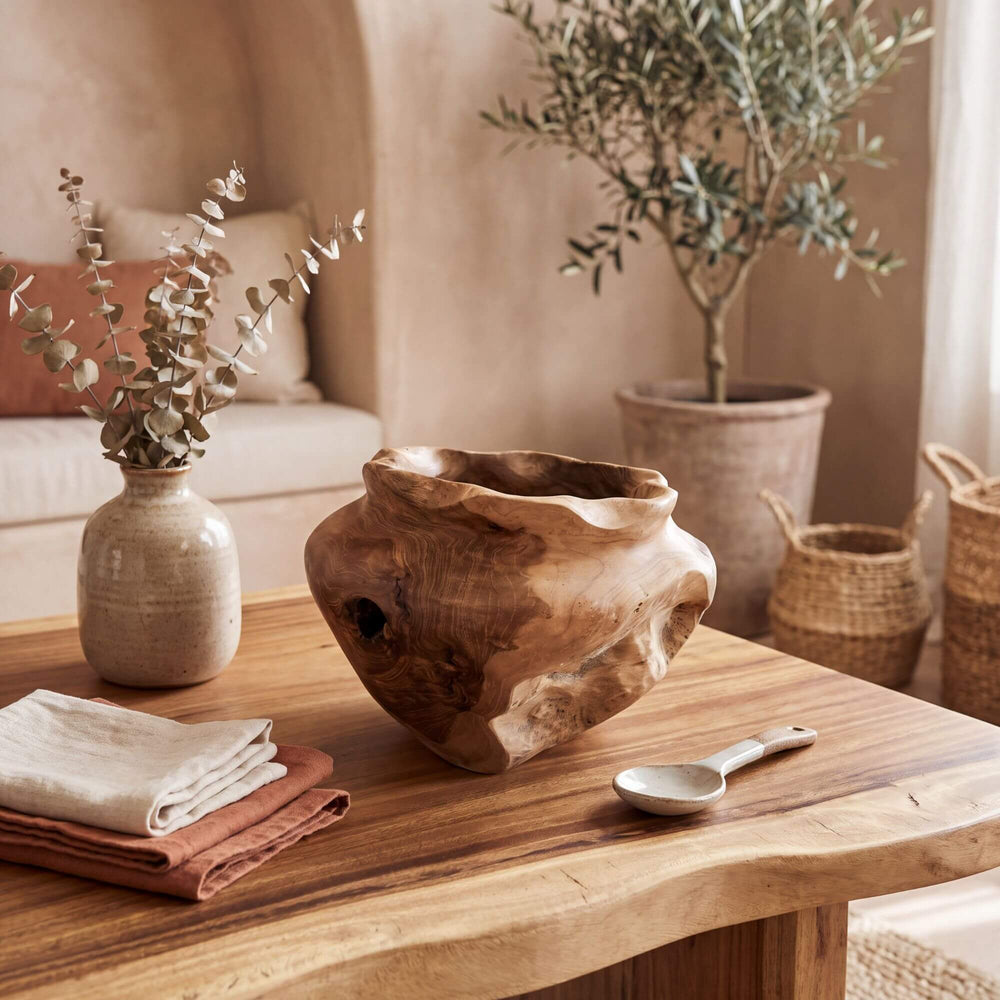 Tanis teak root pot styled on a wooden table in a warm natural interior