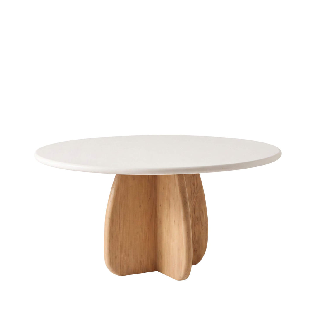 Front view of the Tao round dining table with an off-white microcement top and sculptural sungkai wood pedestal base