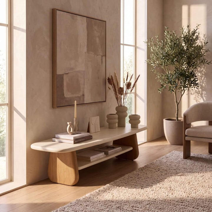 Tao microcement TV console styled in a warm neutral living room beneath wall art and decorative accessories