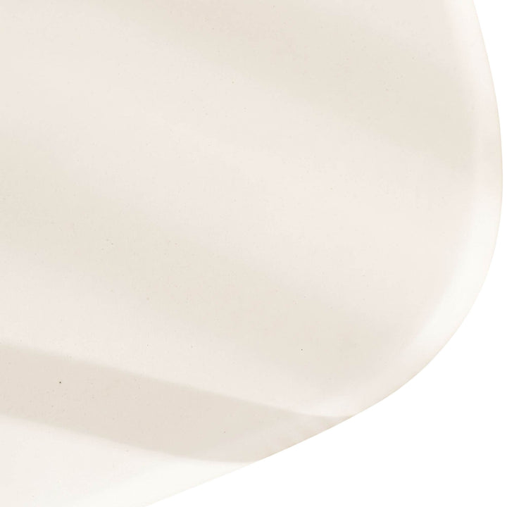 Close-up of the Tao TV console showing its softly rounded microcement edge and smooth mineral finish