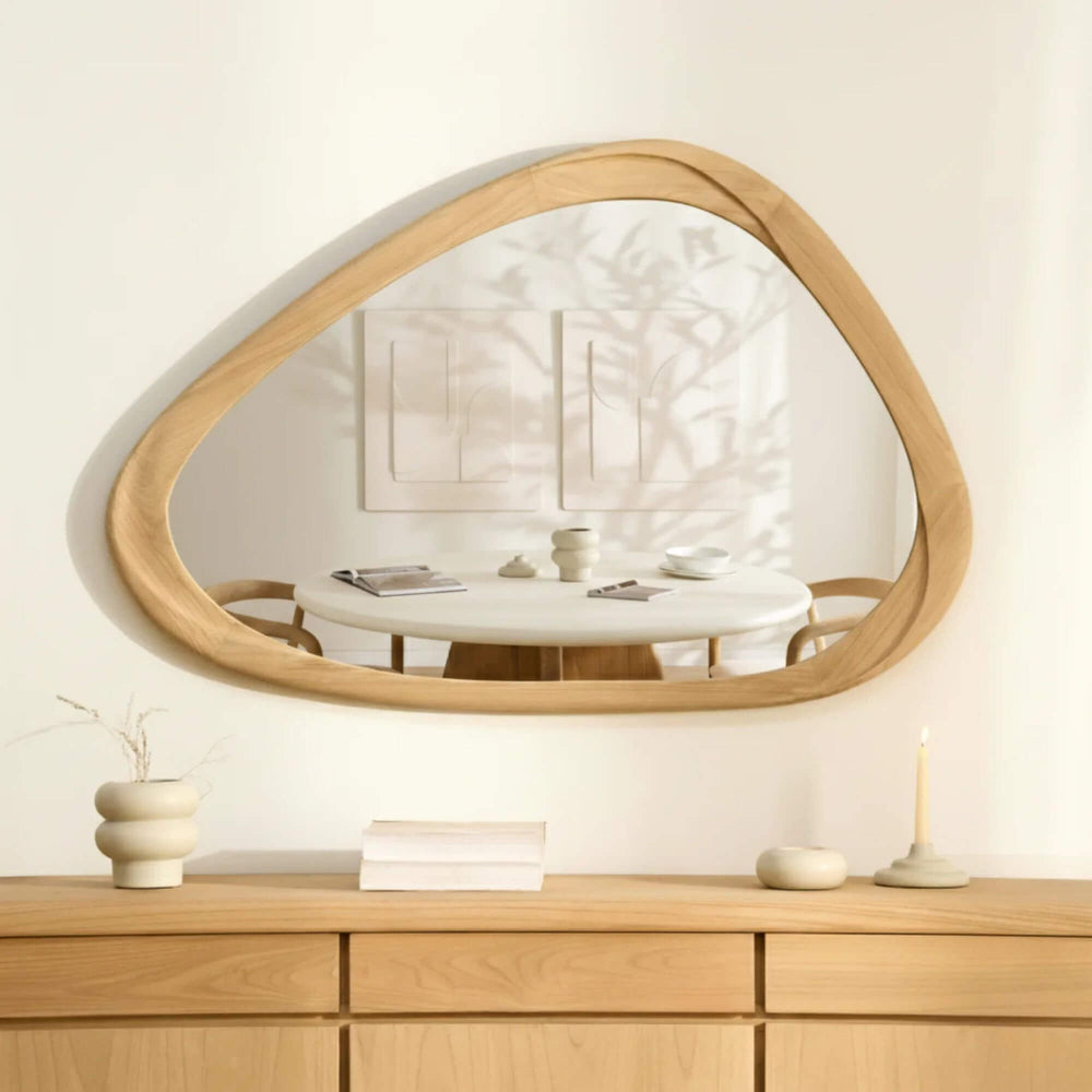 Tao sungkai wood mirror styled horizontally above a wooden sideboard in a bright neutral interior