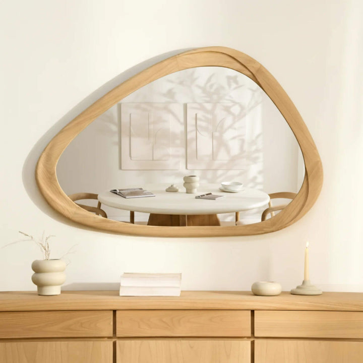 Tao sungkai wood mirror styled horizontally above a wooden sideboard in a bright neutral interior