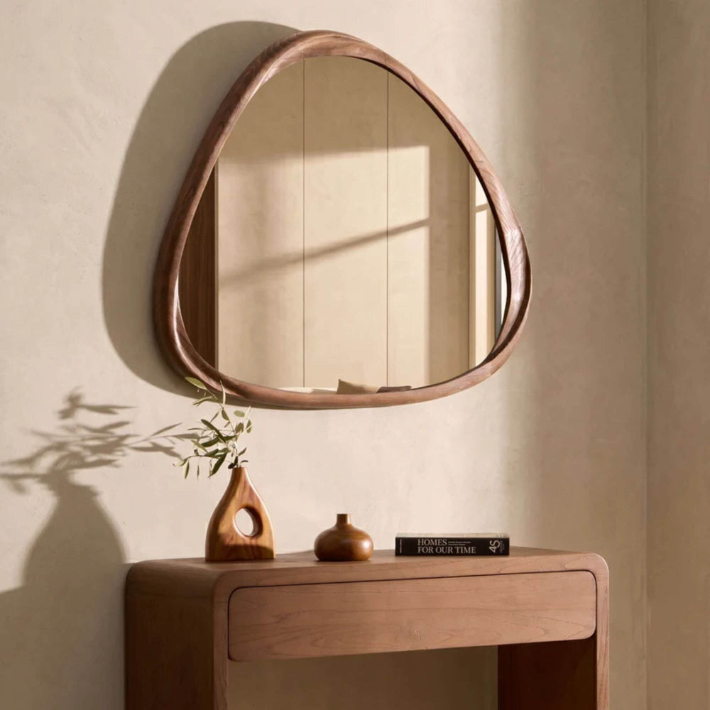 Tao sungkai wood mirror styled above a wooden console in a warm neutral interior