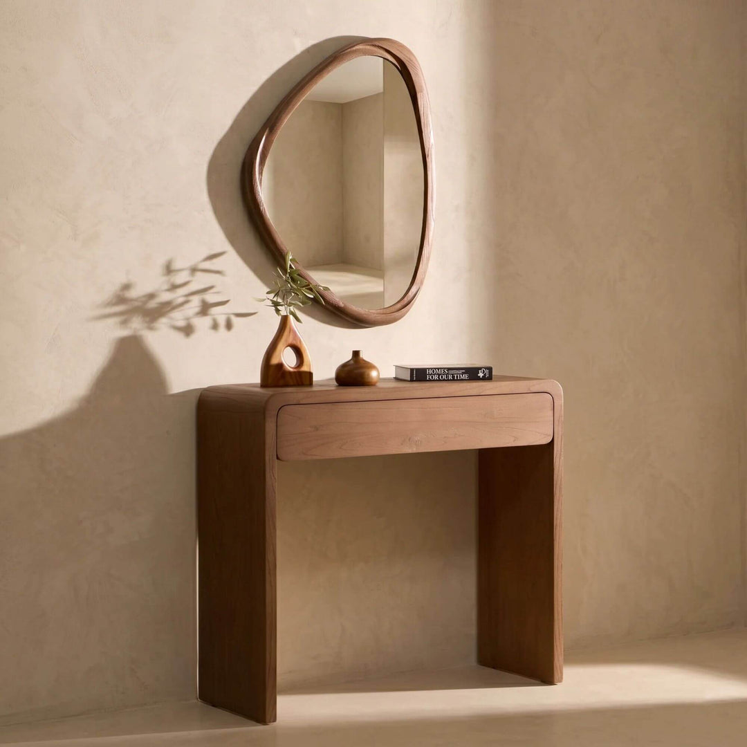 Tao wall mirror displayed above a console table in a Mediterranean-inspired entrance space