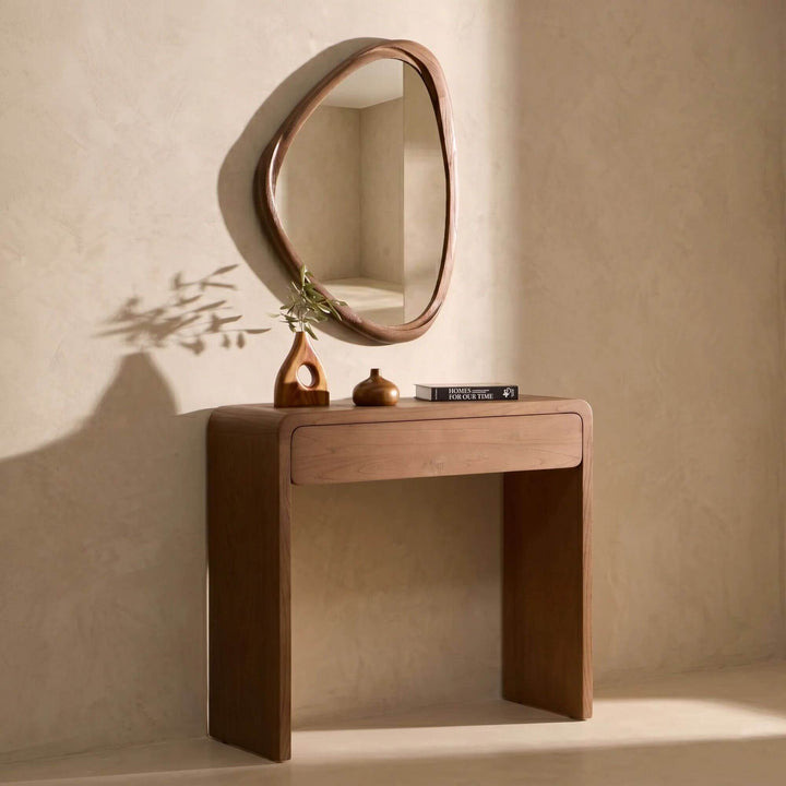 Tao wall mirror displayed above a console table in a Mediterranean-inspired entrance space