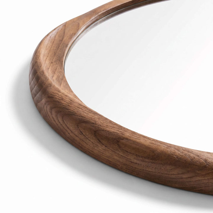 Close-up of the Tao mirror showing the natural grain and rounded profile of the sungkai wood frame