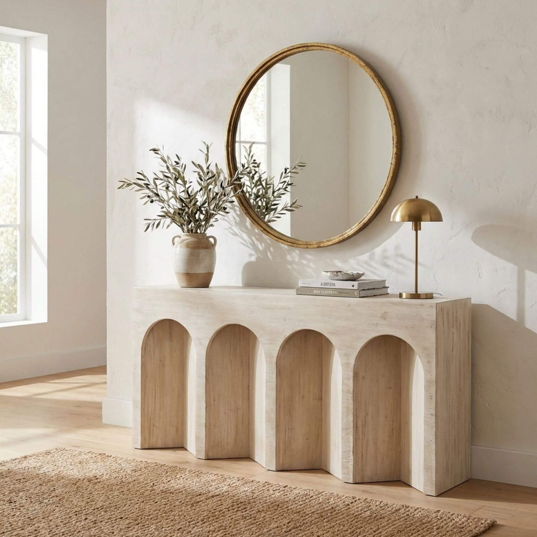 Styled interior setting featuring the Tarkine console beneath a round wall mirror.