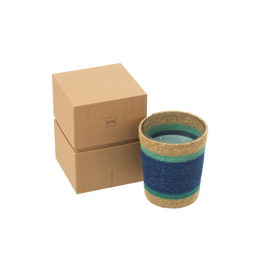 Tazirit candle photographed with packaging boxes emphasizing artisanal presentation.