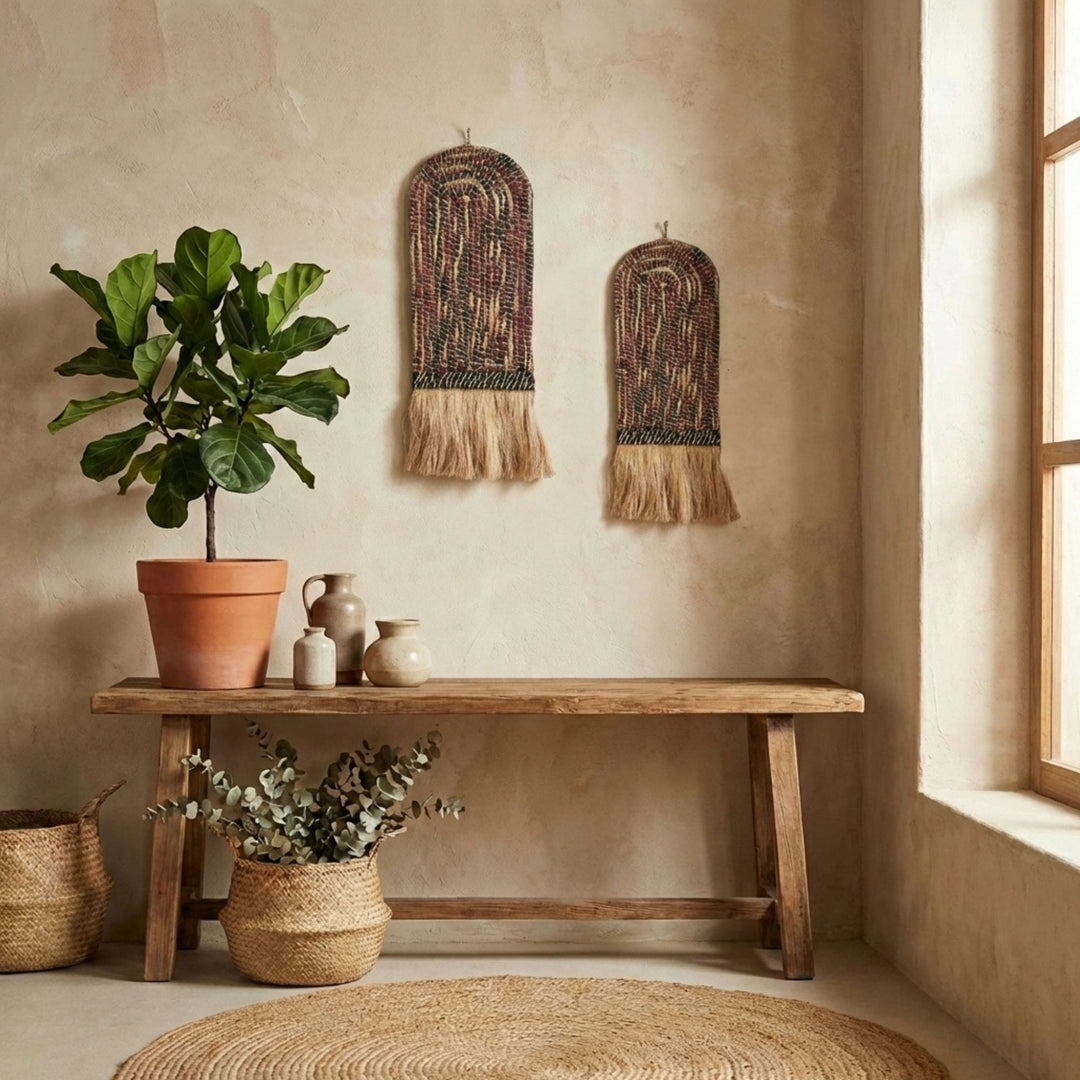 Nest living room with wooden bench, plants, and Teguh wall deco art