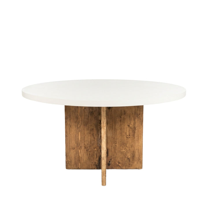Front view of Terraline microcement round dining table showing its smooth circular top and solid wooden base.