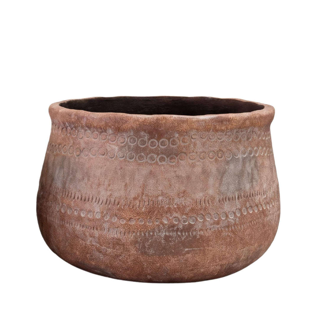 Front view of the large planter highlighting its rounded shape and weathered decorative texture.