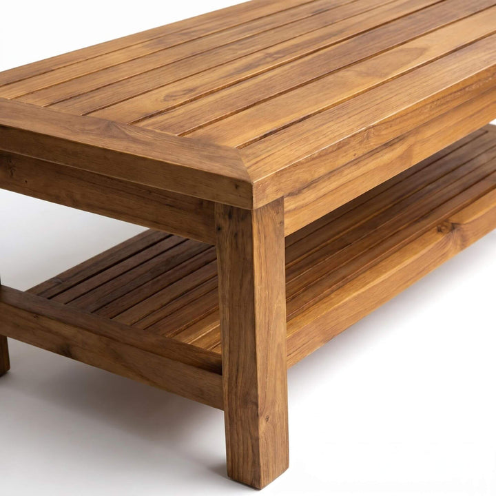 Close-up detail of the tabletop corner and lower shelf showing the natural teak wood grain.