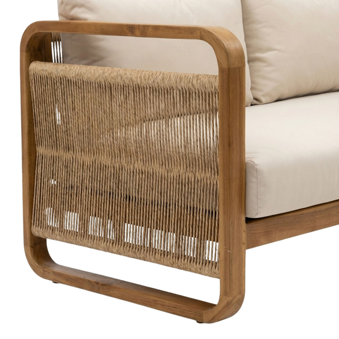 Close-up of the synthetic rattan side panel and smooth teak wood armrest detail.
