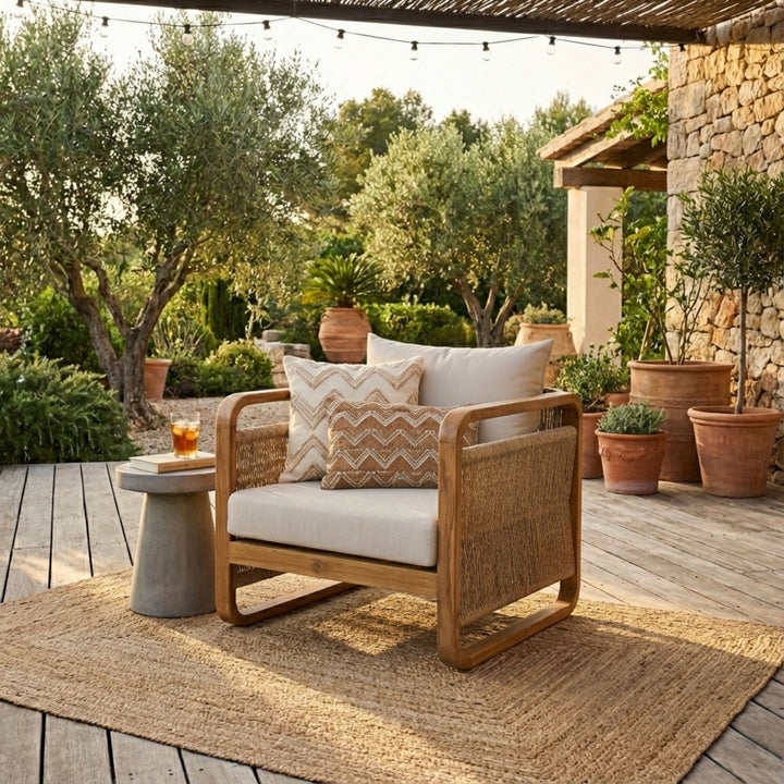 Styled outdoor setting featuring the Thai Fiber One Seater Sofa on a terrace with natural decor.