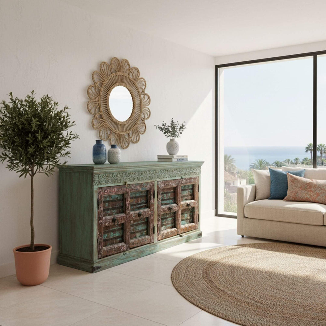 Styled living room featuring the turquoise Thoha Buffet against a bright wall.