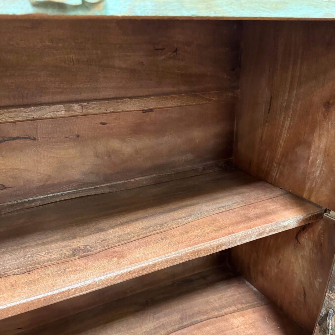 Interior shelving of the Thoha Buffet showing spacious wooden storage.