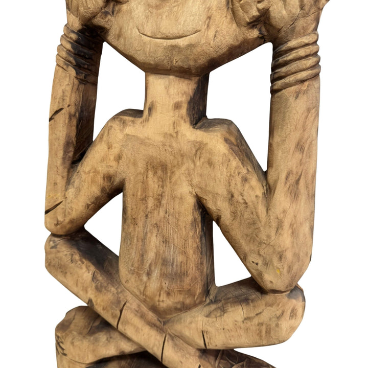 Detailed view of the lower carving and natural teak wood texture of the Timor Totem.