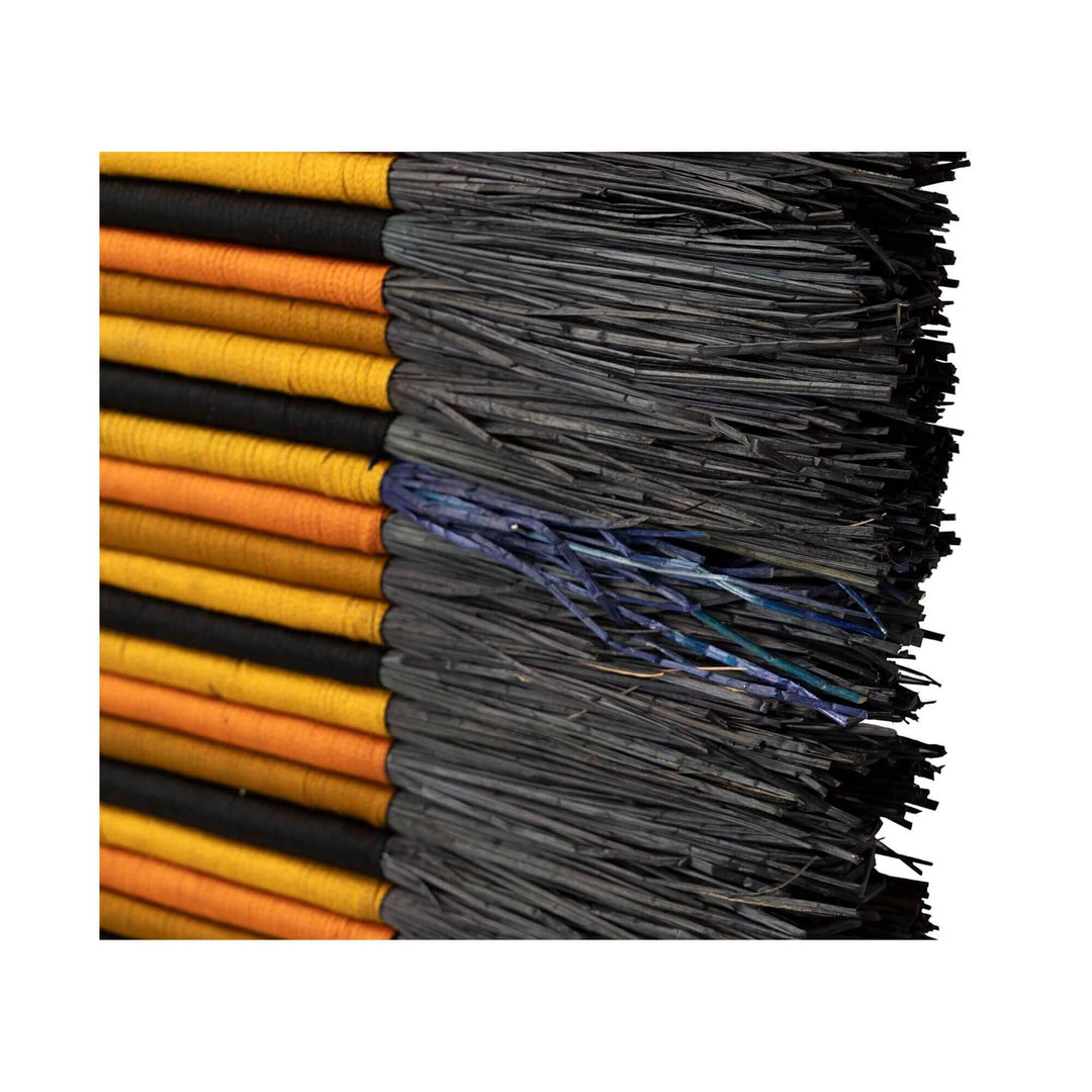 Close-up of modern wall decoration with geometric tribal-inspired design in natural materials.