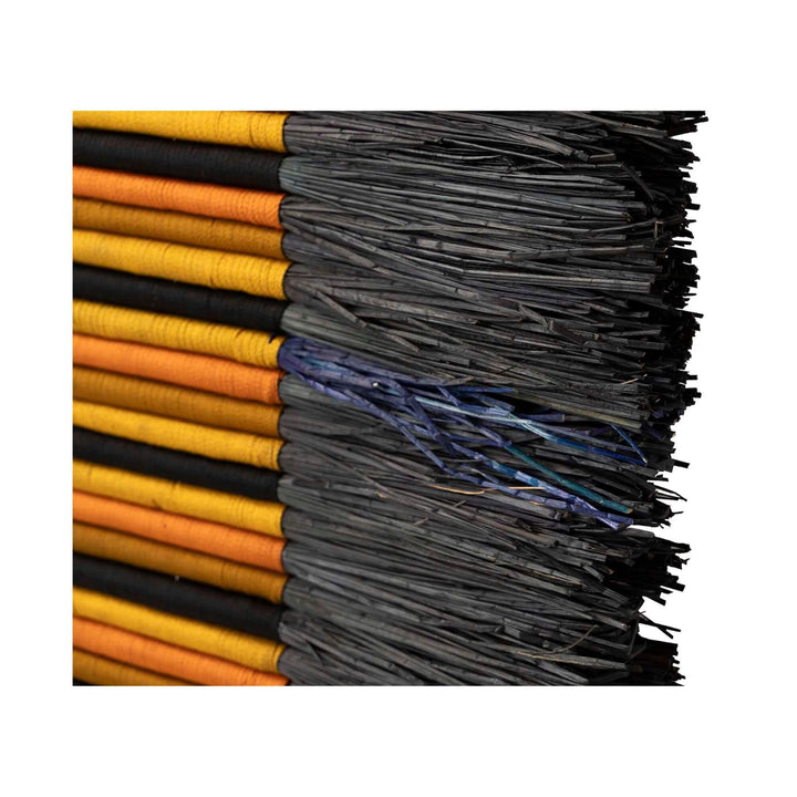 Close-up of modern wall decoration with geometric tribal-inspired design in natural materials.