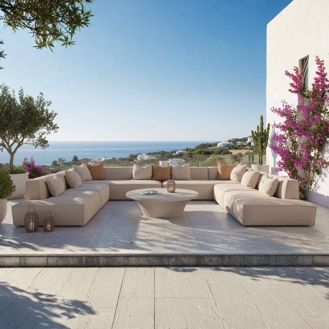 Modern terrace with a TOSCANA OUTDOOR SOFA, coffee table, and scenic view of the ocean.