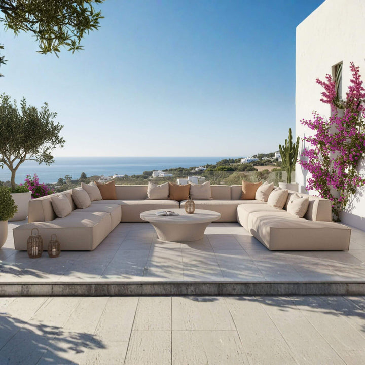 Modern terrace with a TOSCANA OUTDOOR SOFA, coffee table, and scenic view of the ocean.