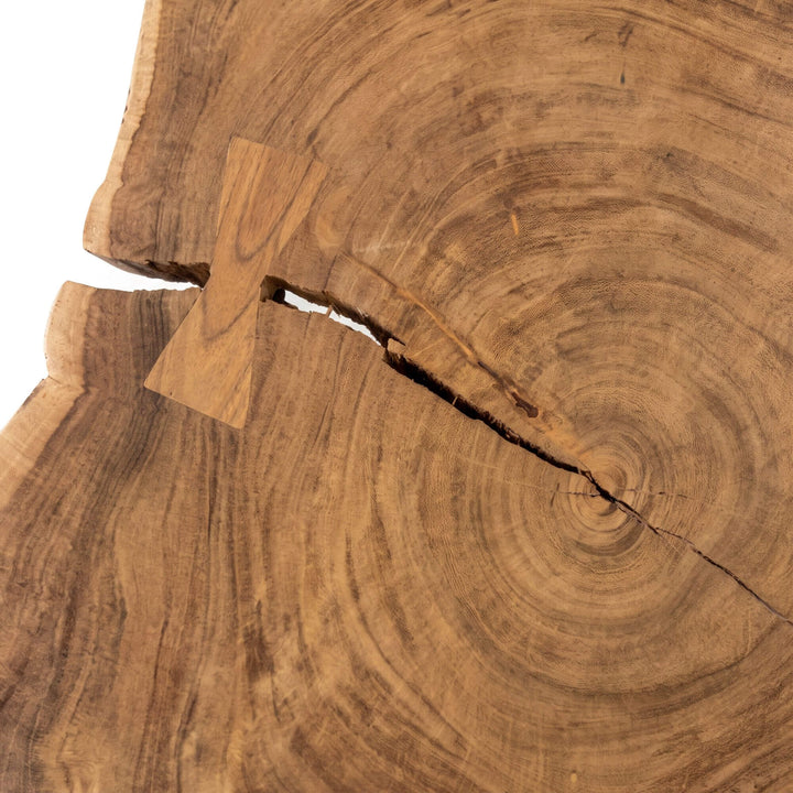 Detail view of the Tree coffee table showing natural cracks and butterfly joint repairs in the solid wood top