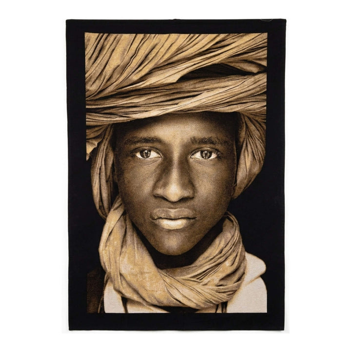 Front view of the Tuareg Child Tapestry featuring a portrait with traditional head wrap in earthy tones.